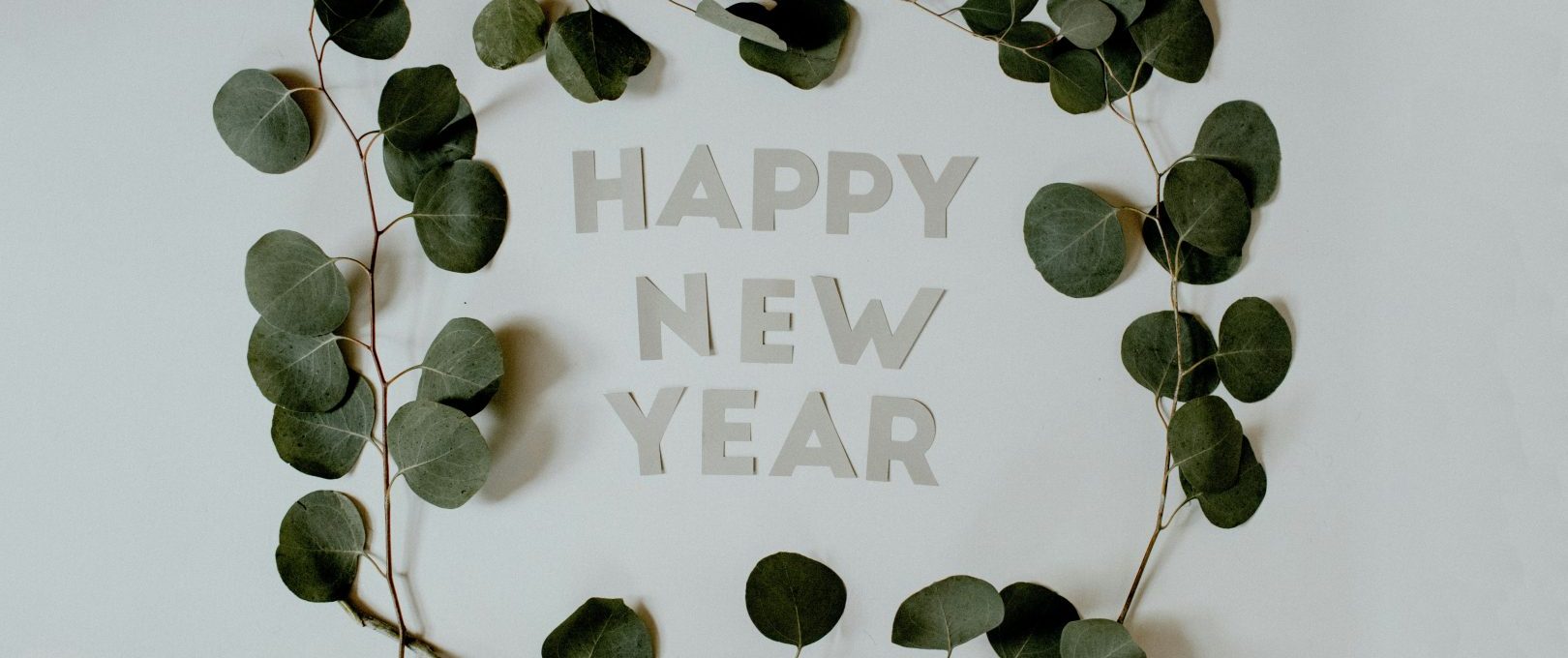 happy new year greeting card with eucalyptus leaves at The Maxwell